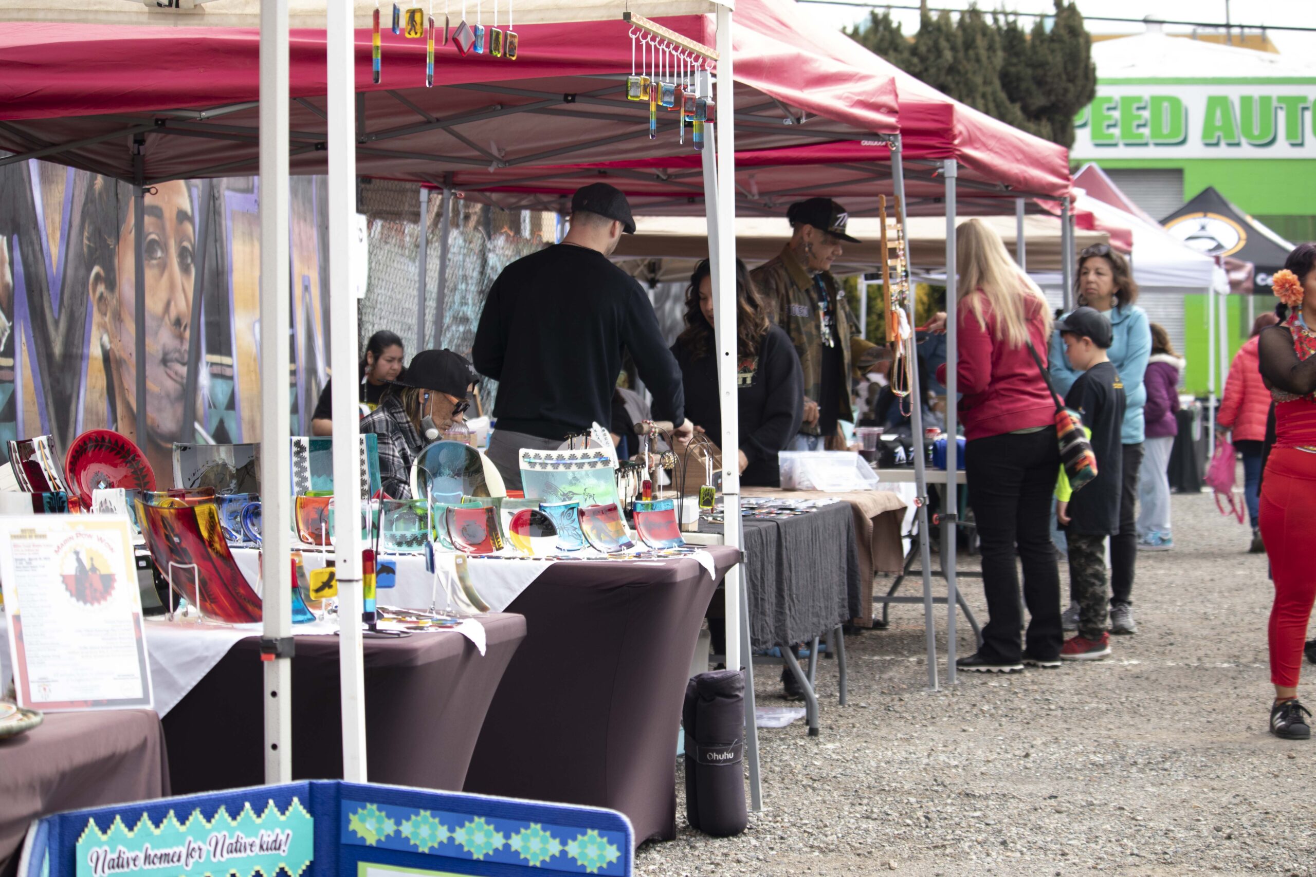 Attendees browsing Indigenous Red Market vendors displaying traditional Native American art